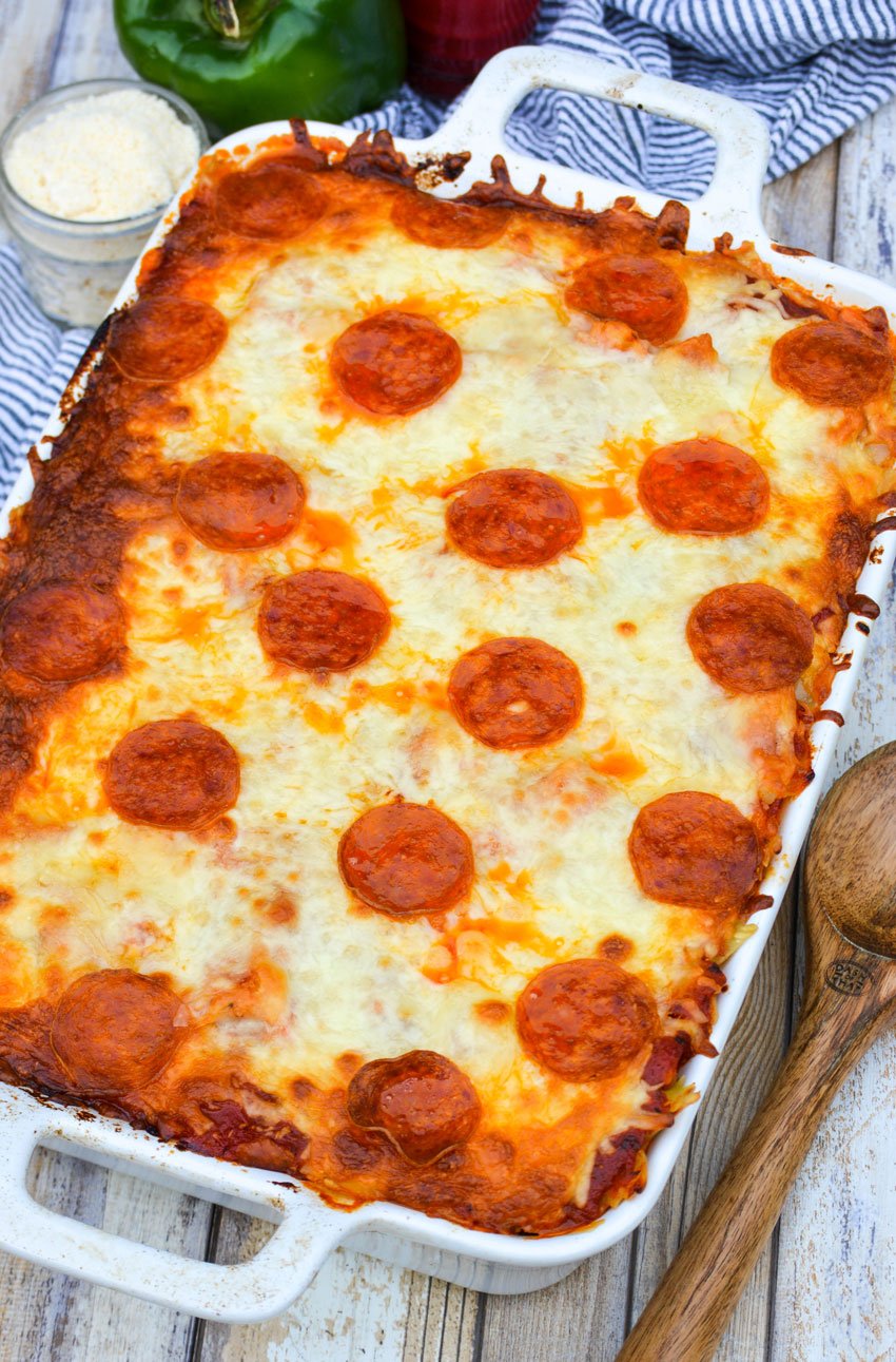 pepperoni topped meat lovers pizza casserole in a white baking dish