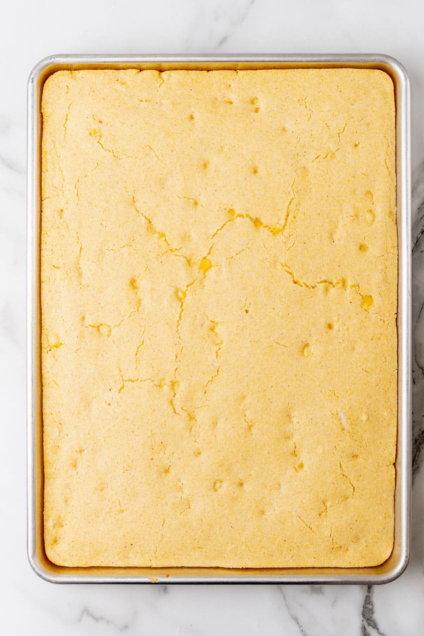 cornbread baked in a rimmed metal baking sheet