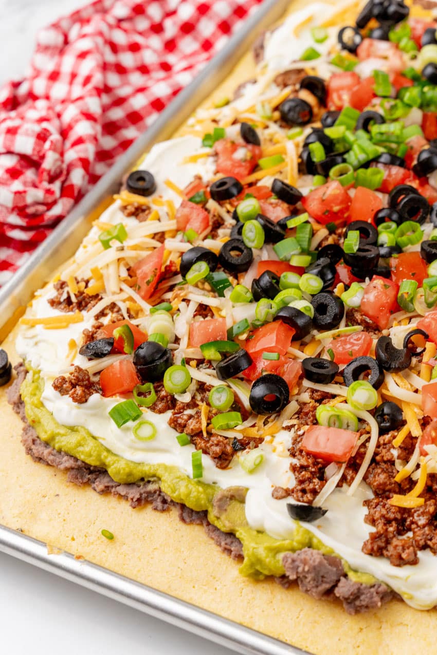 7 layered sheetpan cornbread casserole on a marble countertop