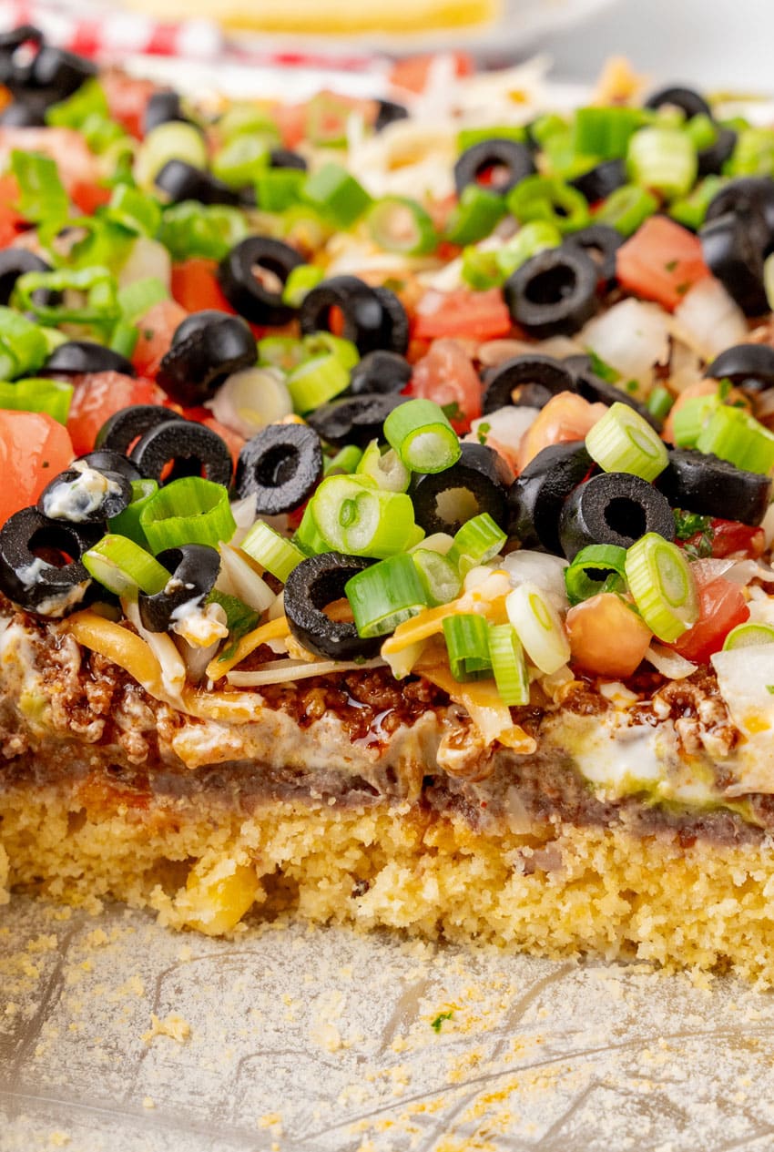 7 layered sheet pan cornbread casserole cut into square slices