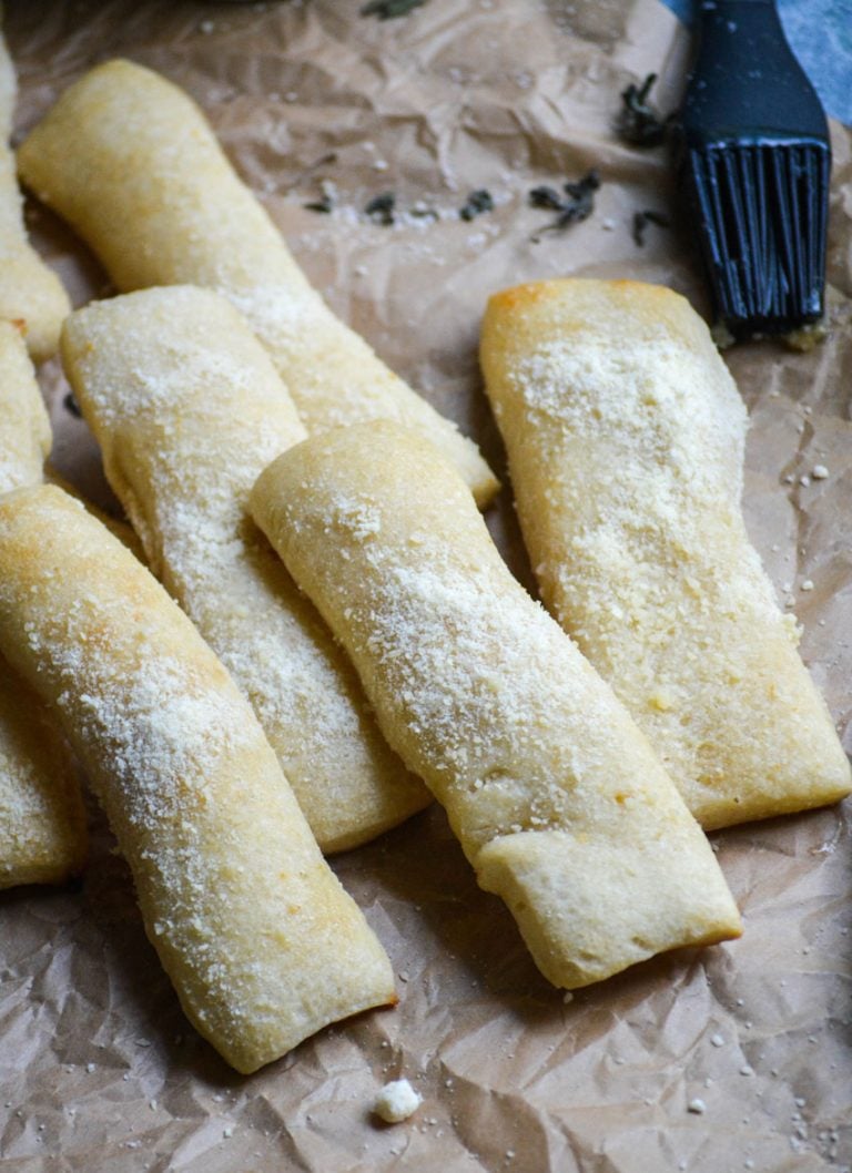 slices of copy cat little caesar's crazy bread shown on a wrinkled piece of brown parchment paper