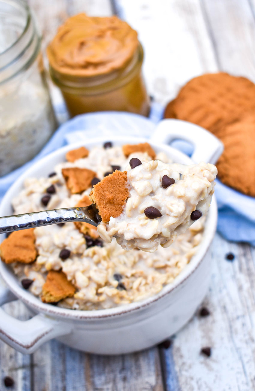 a silver spoon holding up a scoop of peanut butter cookie overnight oats