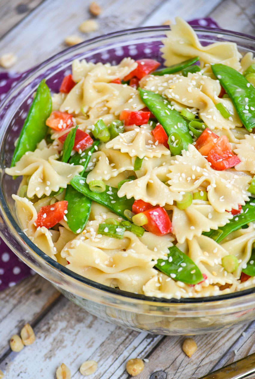 sesame ginger pasta salad in a glass mixing bowl