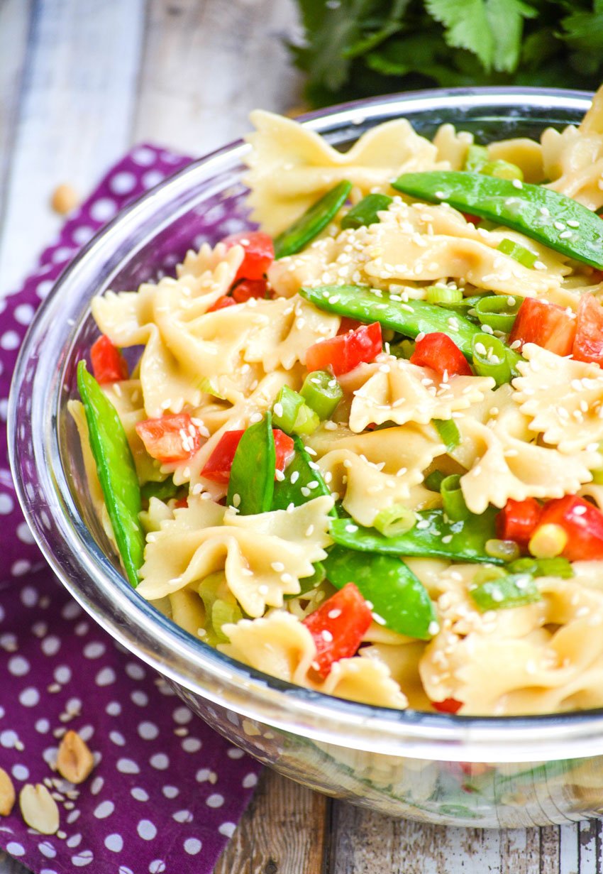 sesame ginger pasta salad in a glass mixing bowl