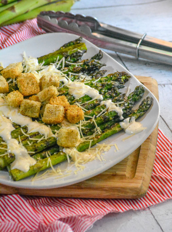 Grilled Asparagus with Garlic Croutons and a drizzle of Caesar Dressing and shredded Parmesan cheese