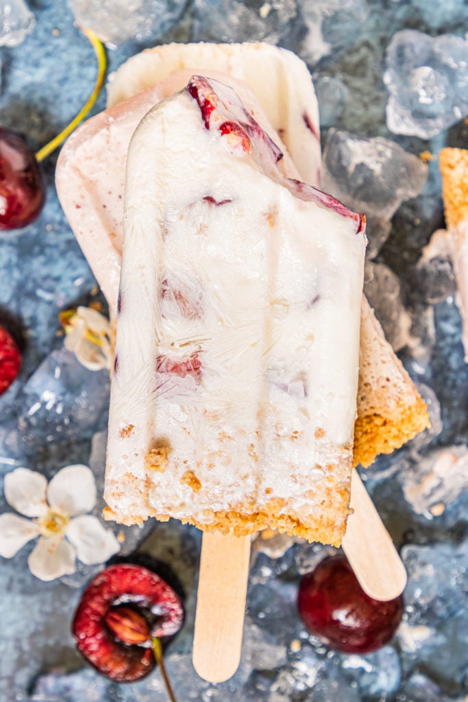 a stack of three cherry cheesecake popsicles
