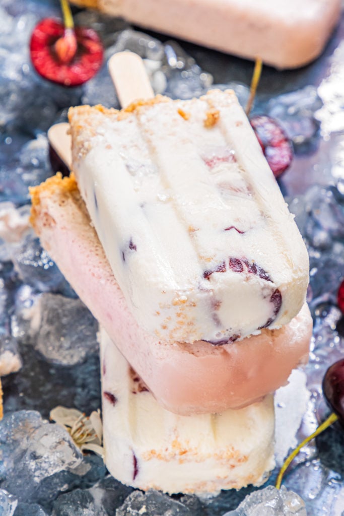 a stack of three cherry cheesecake popsicles