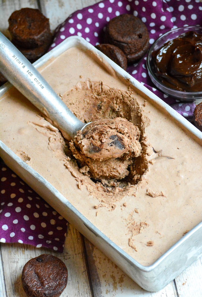 a silver ice cream scoop in a loaf pan filled with no churn fudge brownie ice cream
