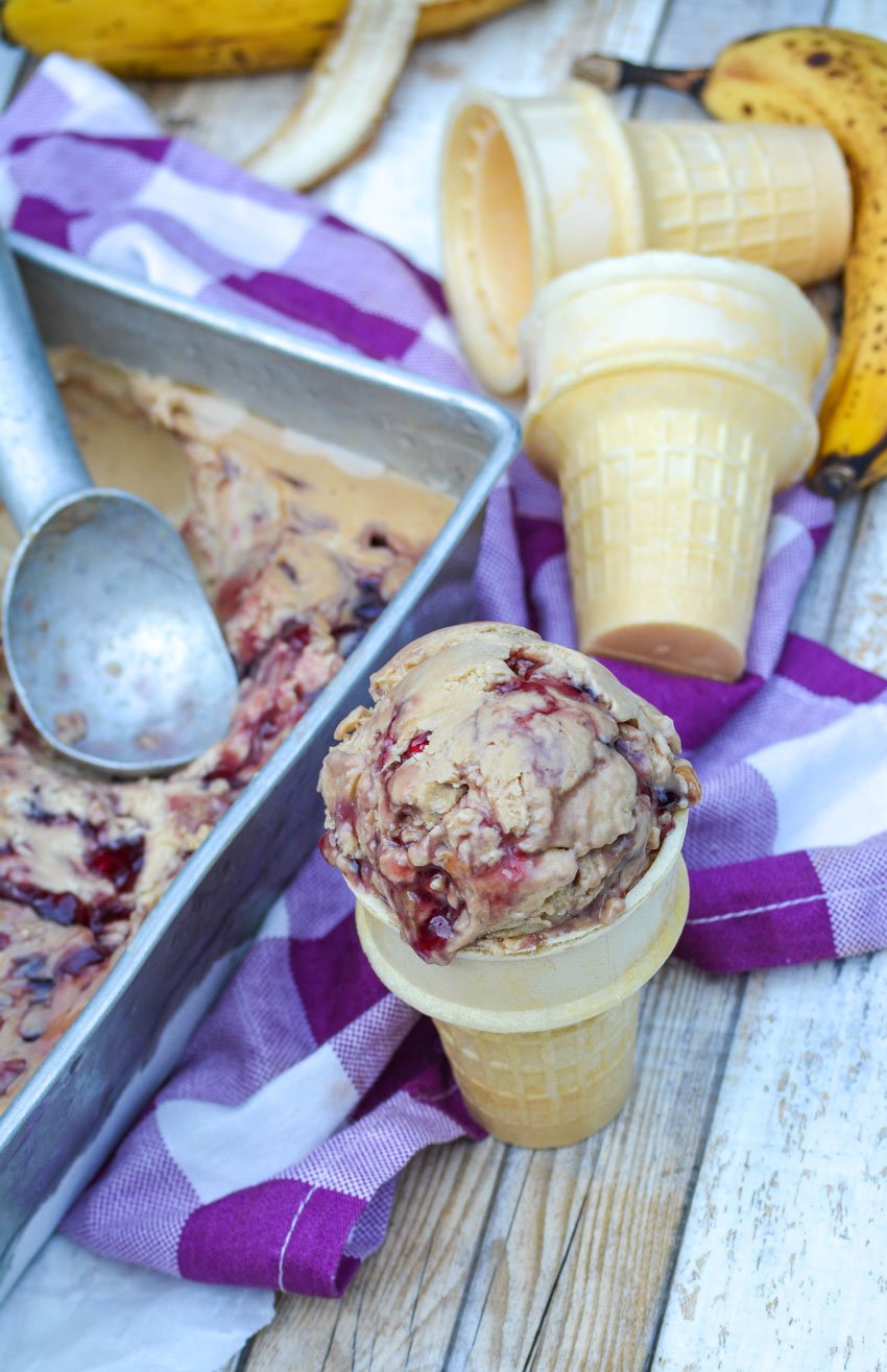 peanut butter and jelly banana ice cream in a sugar cone