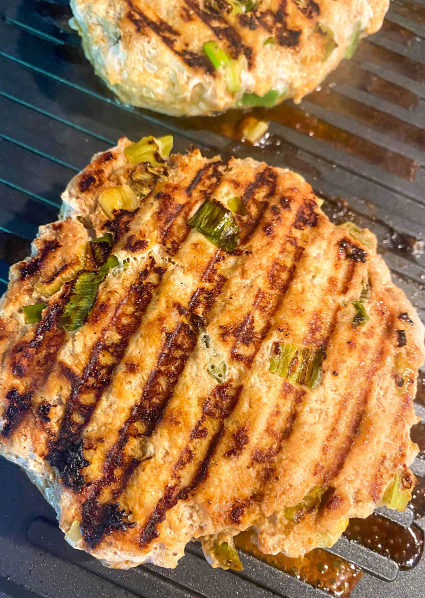 tandoori chicken burgers on a table top grill