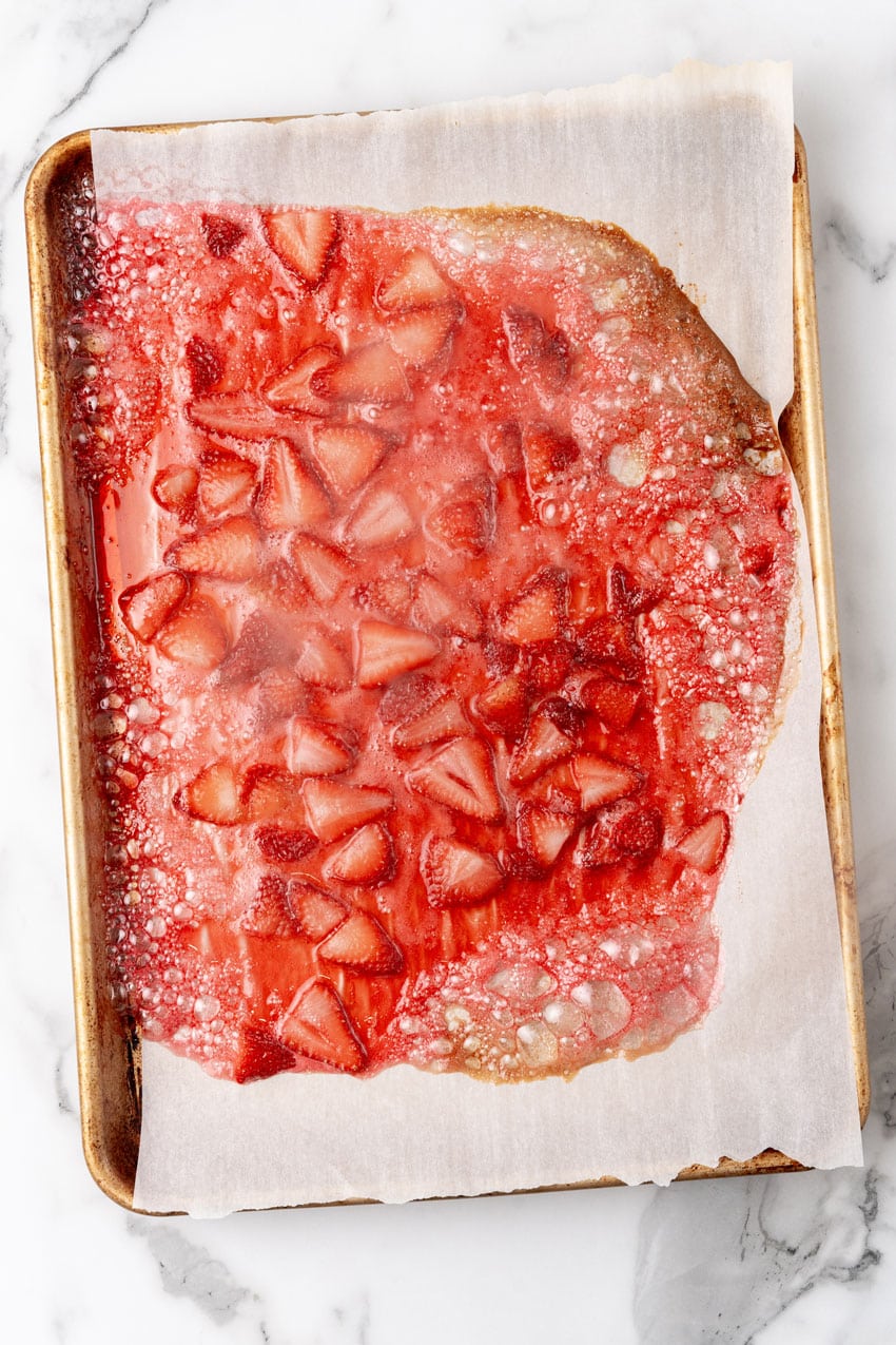 roasted strawberries on a parchment paper lined baking pan