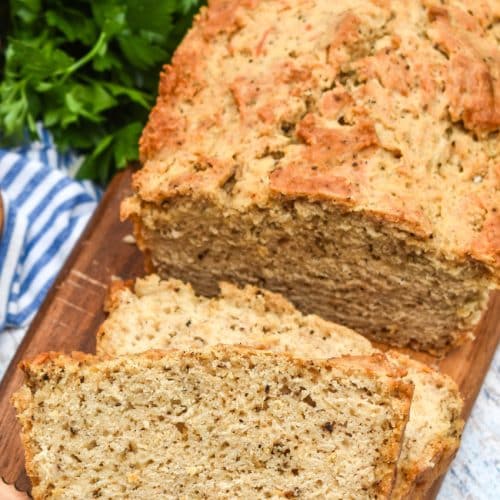 slices of black pepper parmesan beer bread on a wooden cutting board