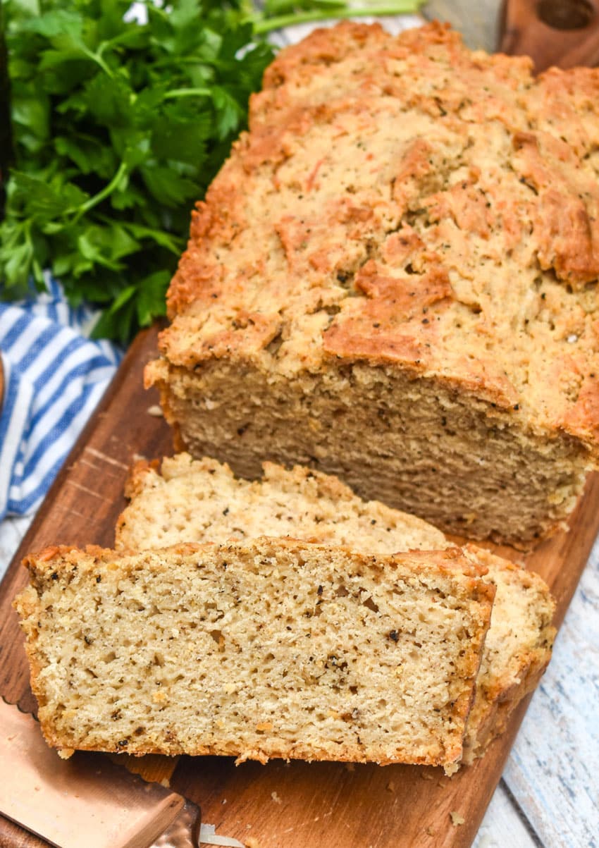 slices of black pepper parmesan beer bread on a wooden cutting board