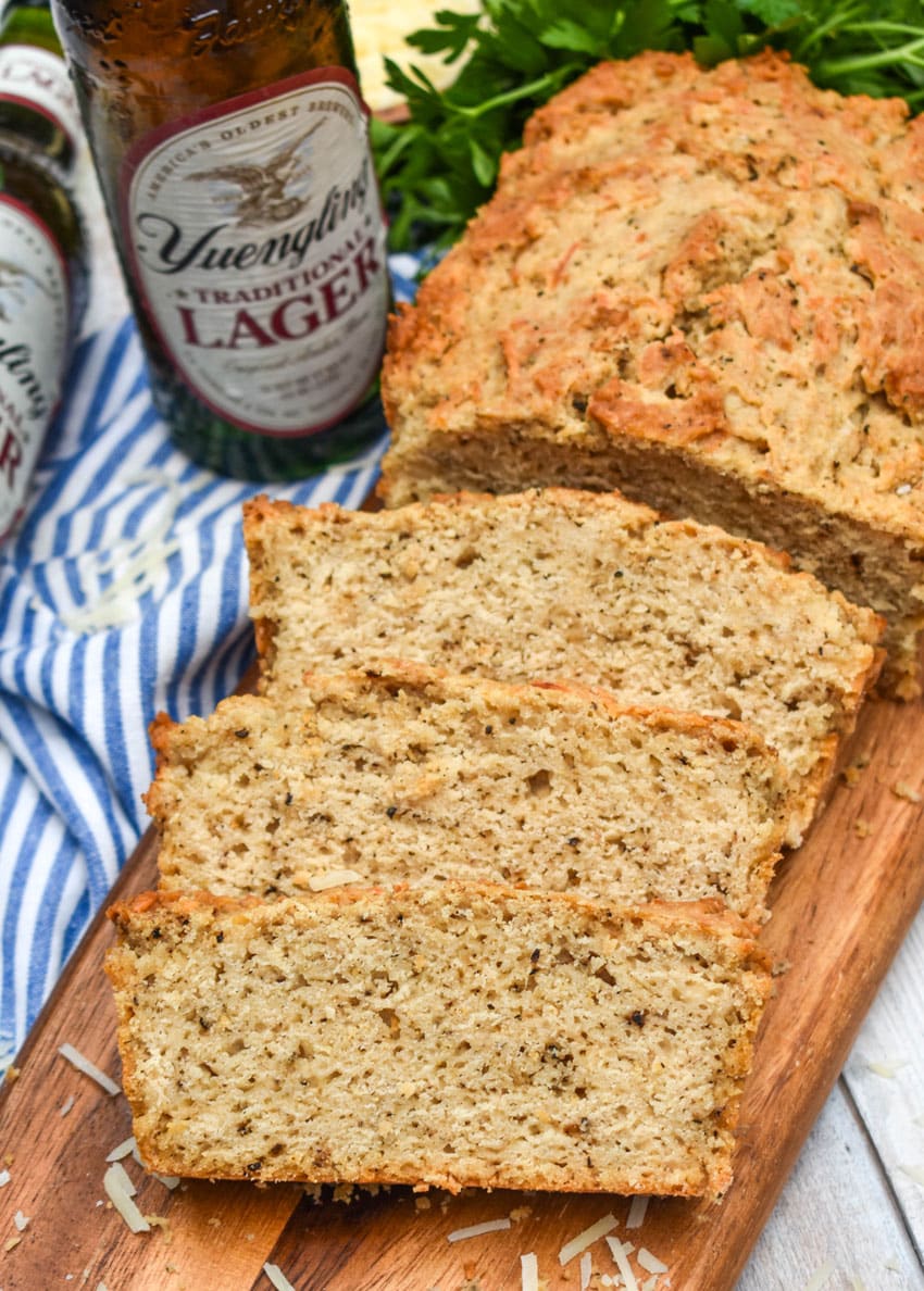 slices of black pepper parmesan beer bread on a wooden cutting board