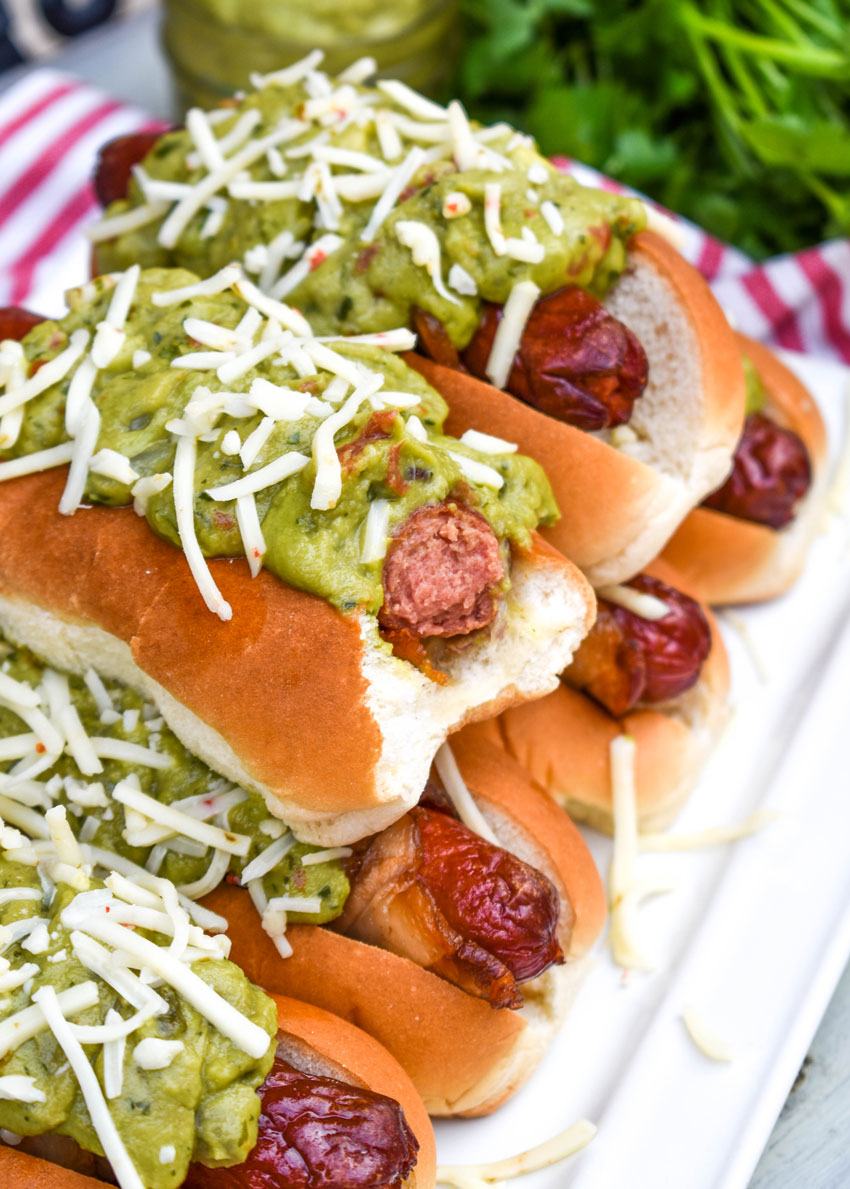 california dogs stacked on a white serving platter