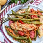one pot balsamic chicken and veggies on a white plate with a fork resting on the side