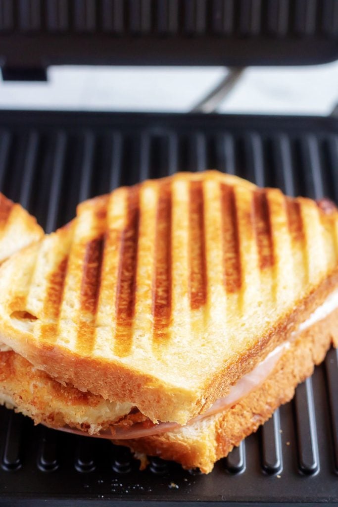 a single Chicken Cordon Bleu Panini shown on a panini press grill