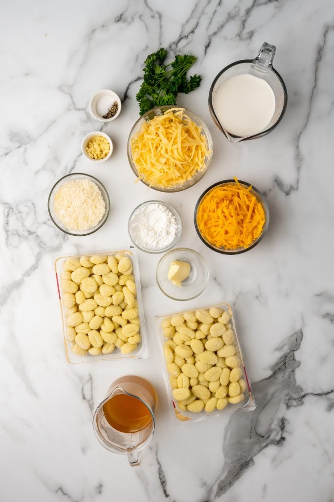 overhead image showing the measured ingredients needed to make a batch of gnocchi mac and cheese