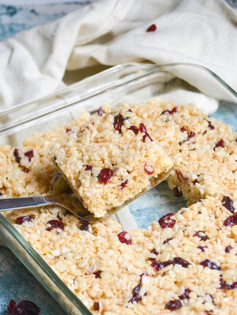 a silver spatula lifting up a cranberry orange rice krispie treat square