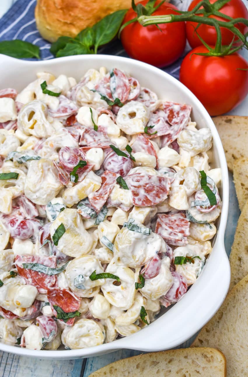 pepperoni basil tortellini salad in a large white serving bowl