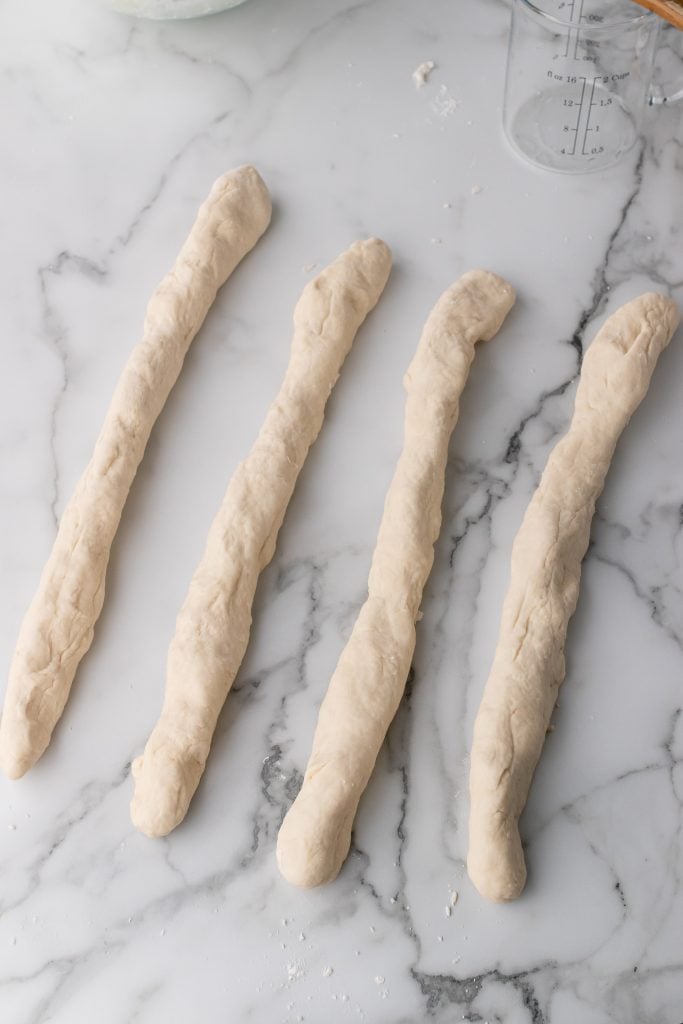 4 long even ropes of french baguette dough