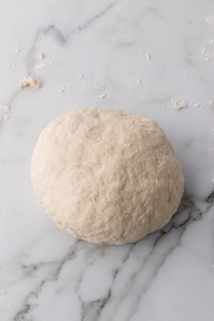 foolproof baguette dough ball on a marble countertop