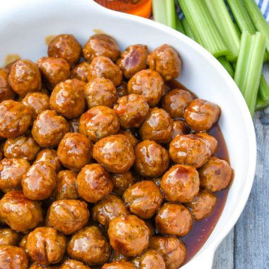 slow cooker honey buffalo meatballs in a large white serving bowl
