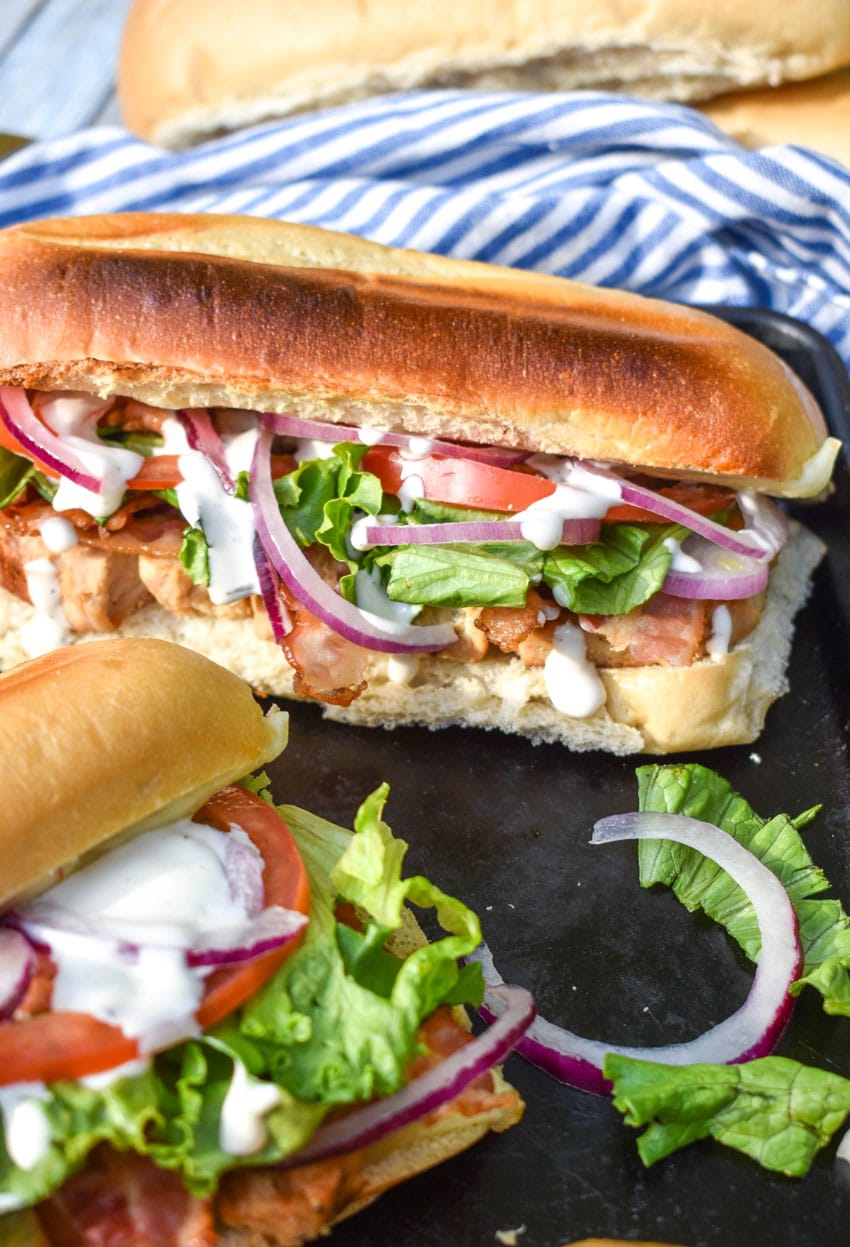 chicken bacon ranch sub sandwiches on a metal baking sheet