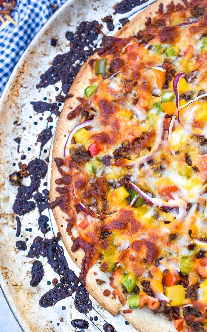 a close up of roadhouse pizza on a metal pizza pan