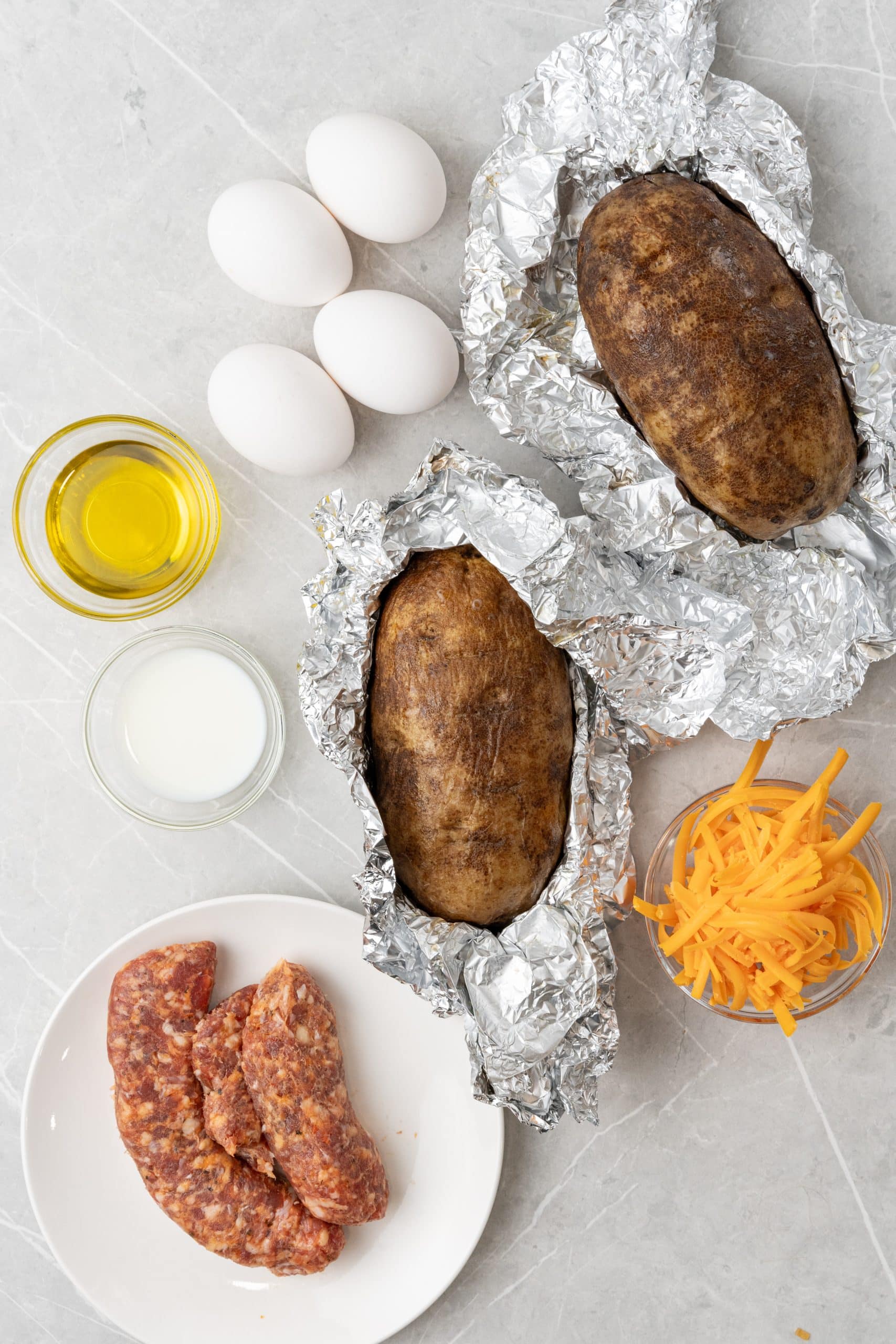 an overhead image showing the measured ingredients needed to make a batch of twice baked breakfast potatoes