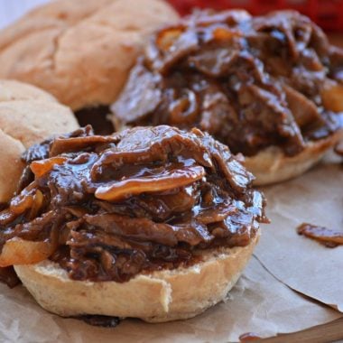 two open faced skillet barbecue beef sandwiches on brown paper