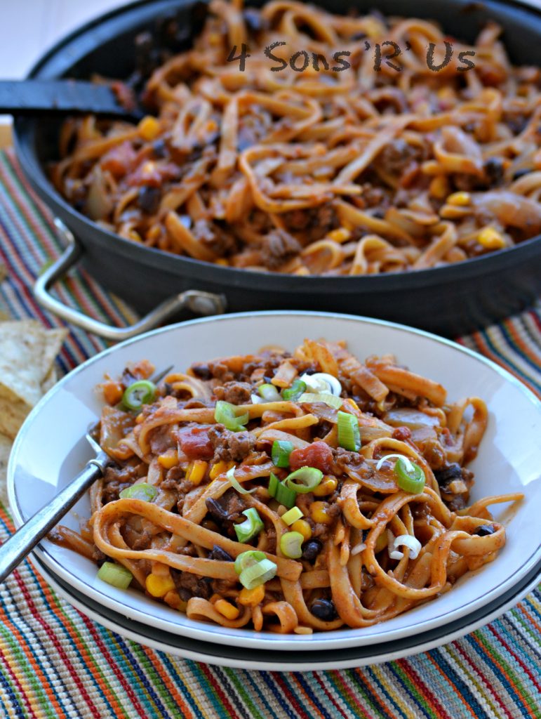 15 Minute Taco Pasta shown served in shallow white bowls with the main skillet in the background
