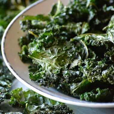 pepper parmesan kale chips in a white bowl