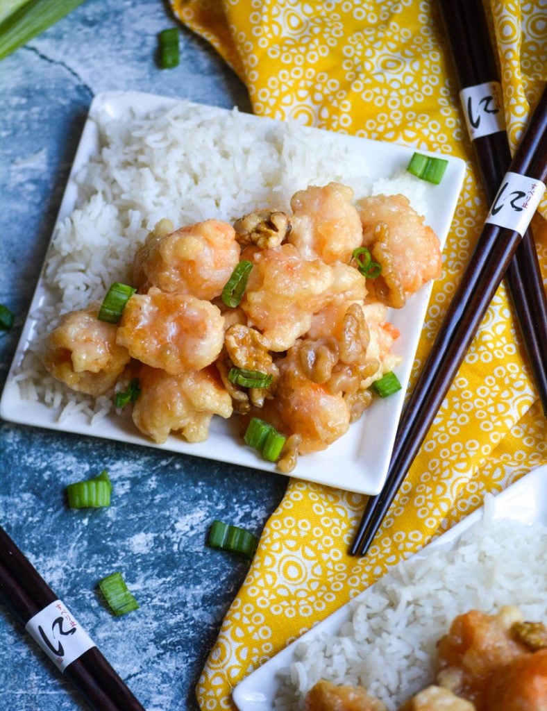 crispy honey walnut shrimp served alongside steamed white rice on a small white plate