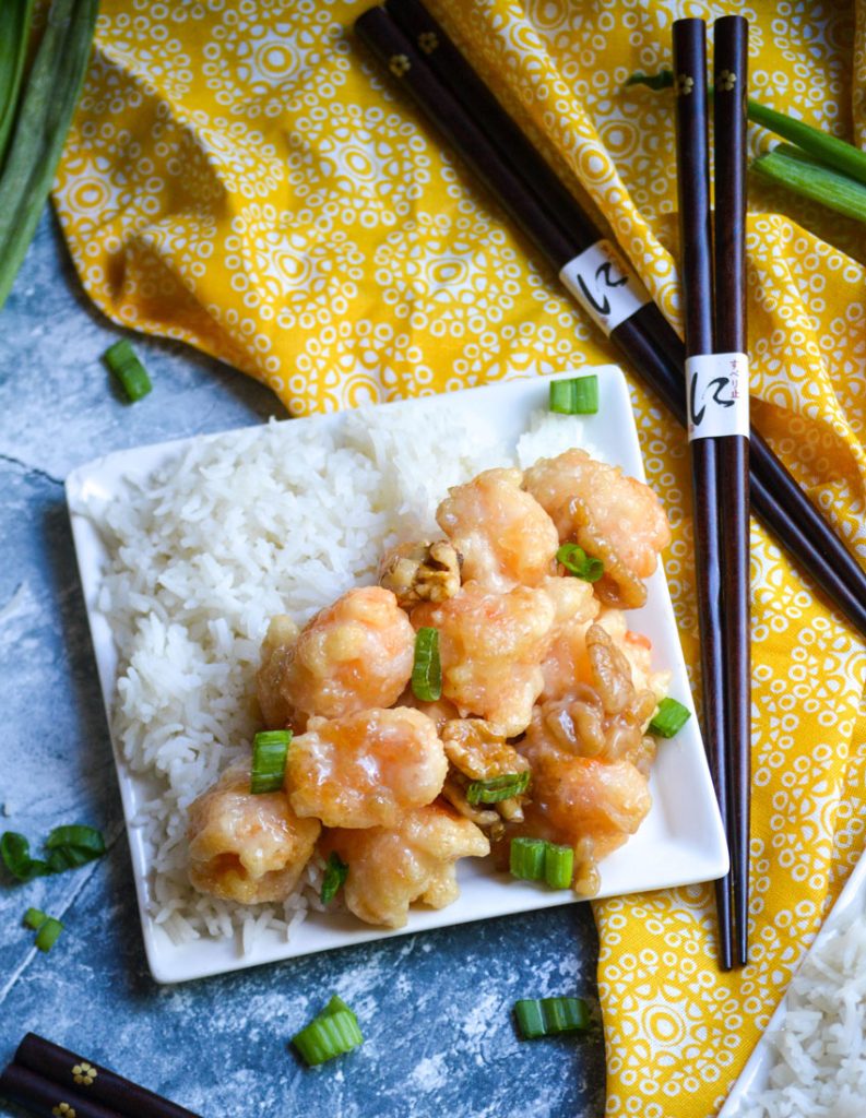 crispy honey walnut shrimp served alongside steamed white rice on a small white plate