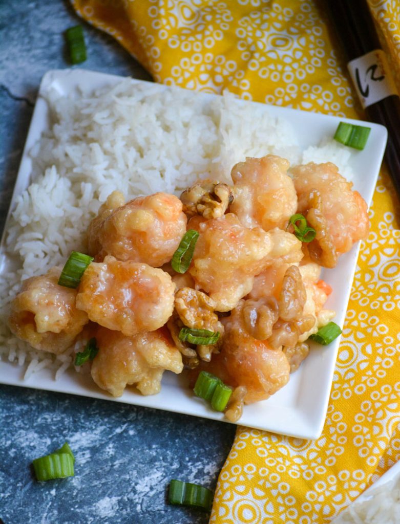 crispy honey walnut shrimp served alongside steamed white rice on a small white plate