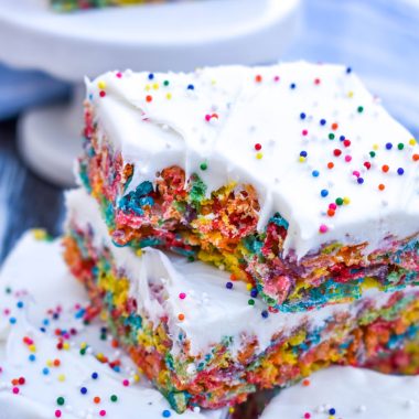 a stack of frosting topped fruity pebbles cereal bars