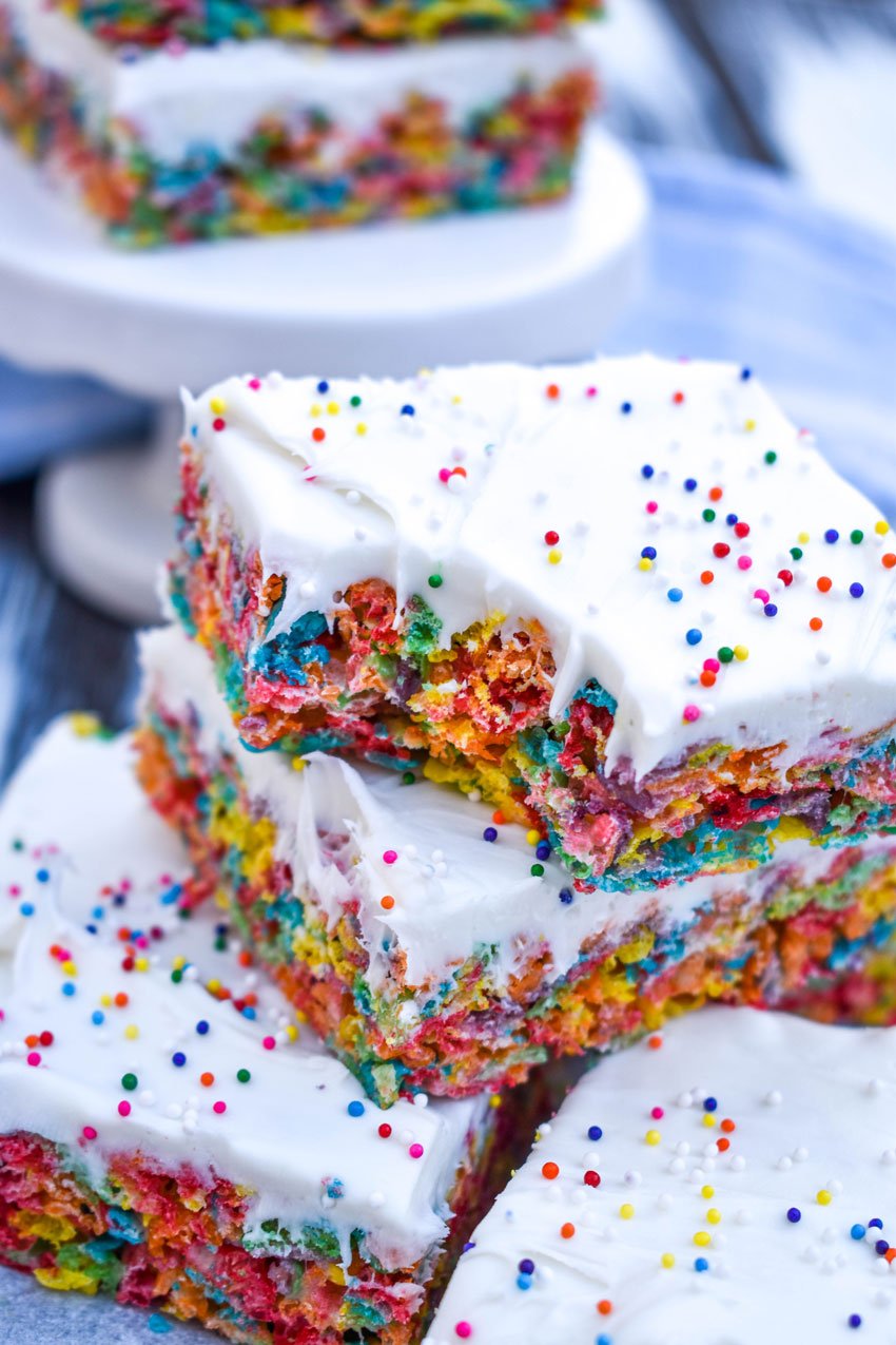 a stack of frosting topped fruity pebbles cereal bars