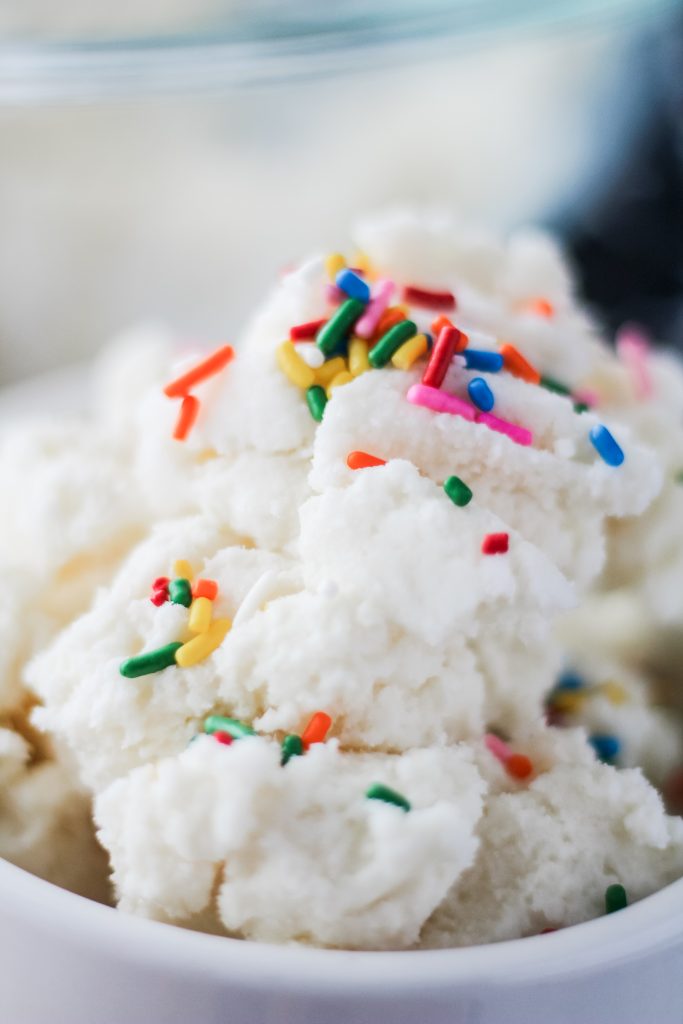 a bowl full of homemade snow cream topped with rainbow sprinkles