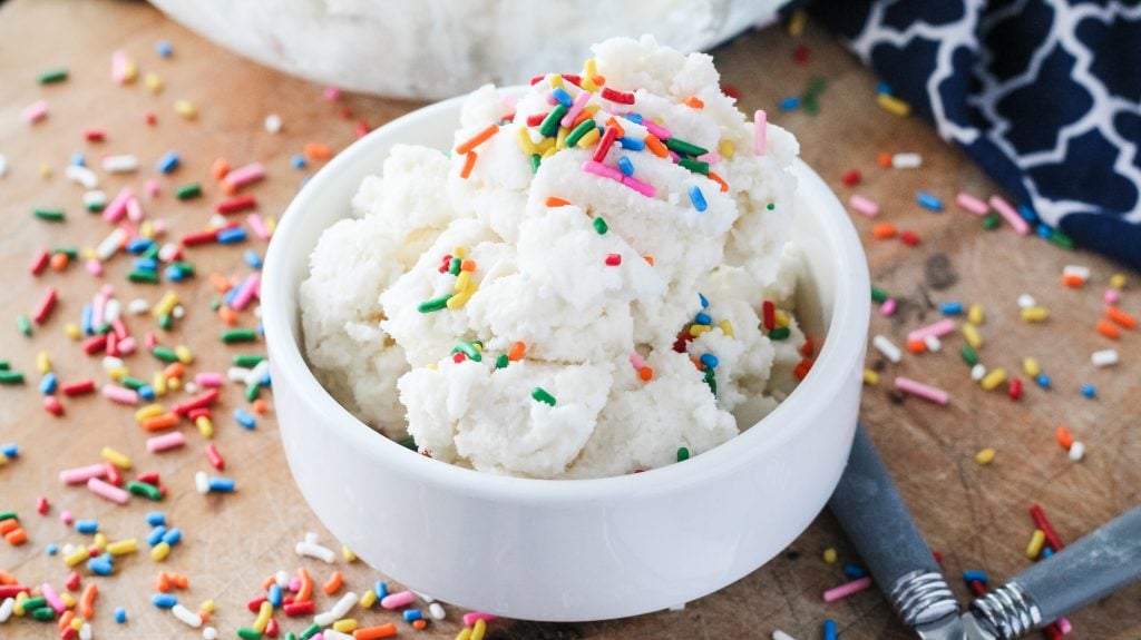 a bowl full of homemade snow cream topped with rainbow sprinkles