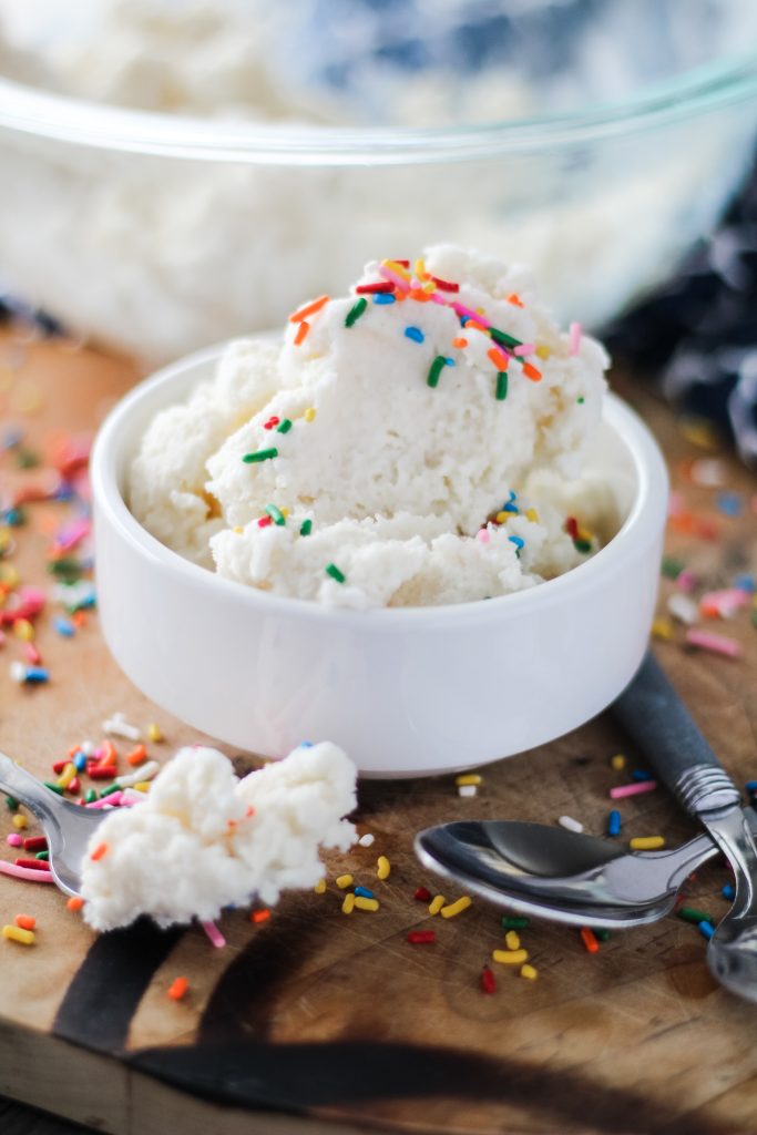 a bowl full of homemade snow cream topped with rainbow sprinkles