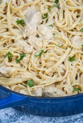 one pot Cajun chicken alfredo pasta in a large blue cast iron enameled dutch oven