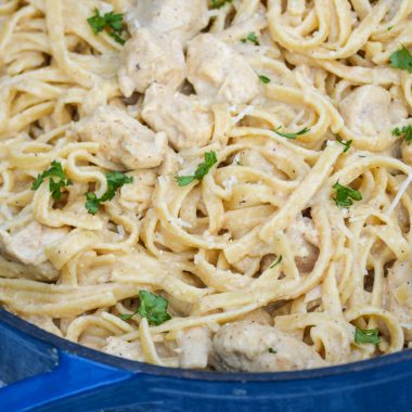 one pot Cajun chicken alfredo pasta in a large blue cast iron enameled dutch oven