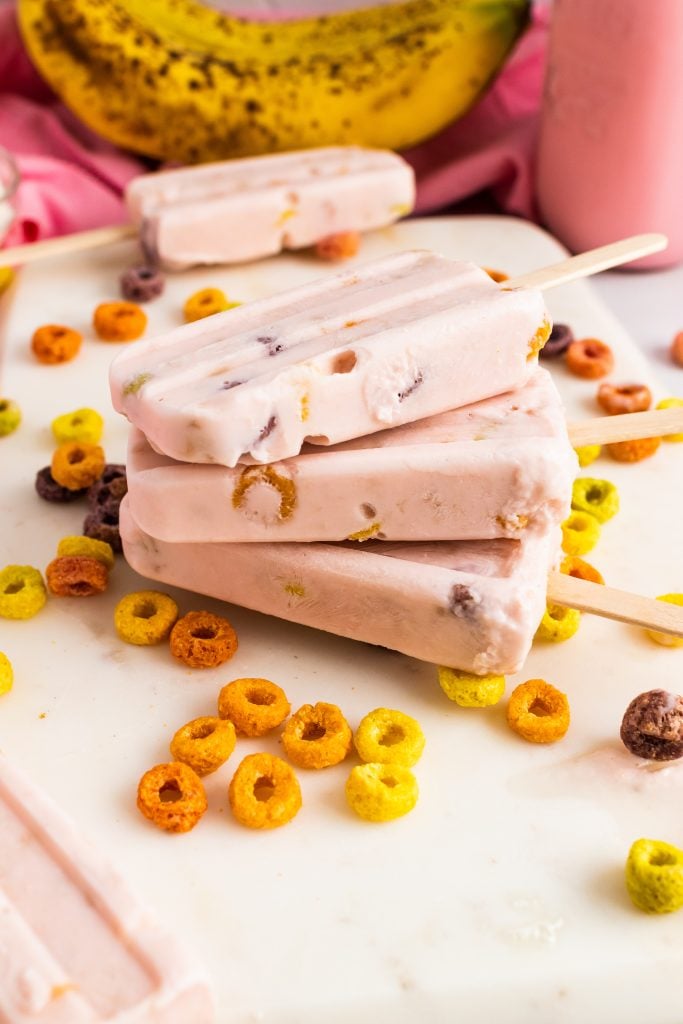 milk and cereal yogurt breakfast pops on a white cutting board