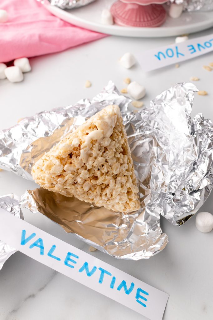 an unwrapped Hershey's Kiss rice krispie treat laying on a crinkled sheet of aluminum foil