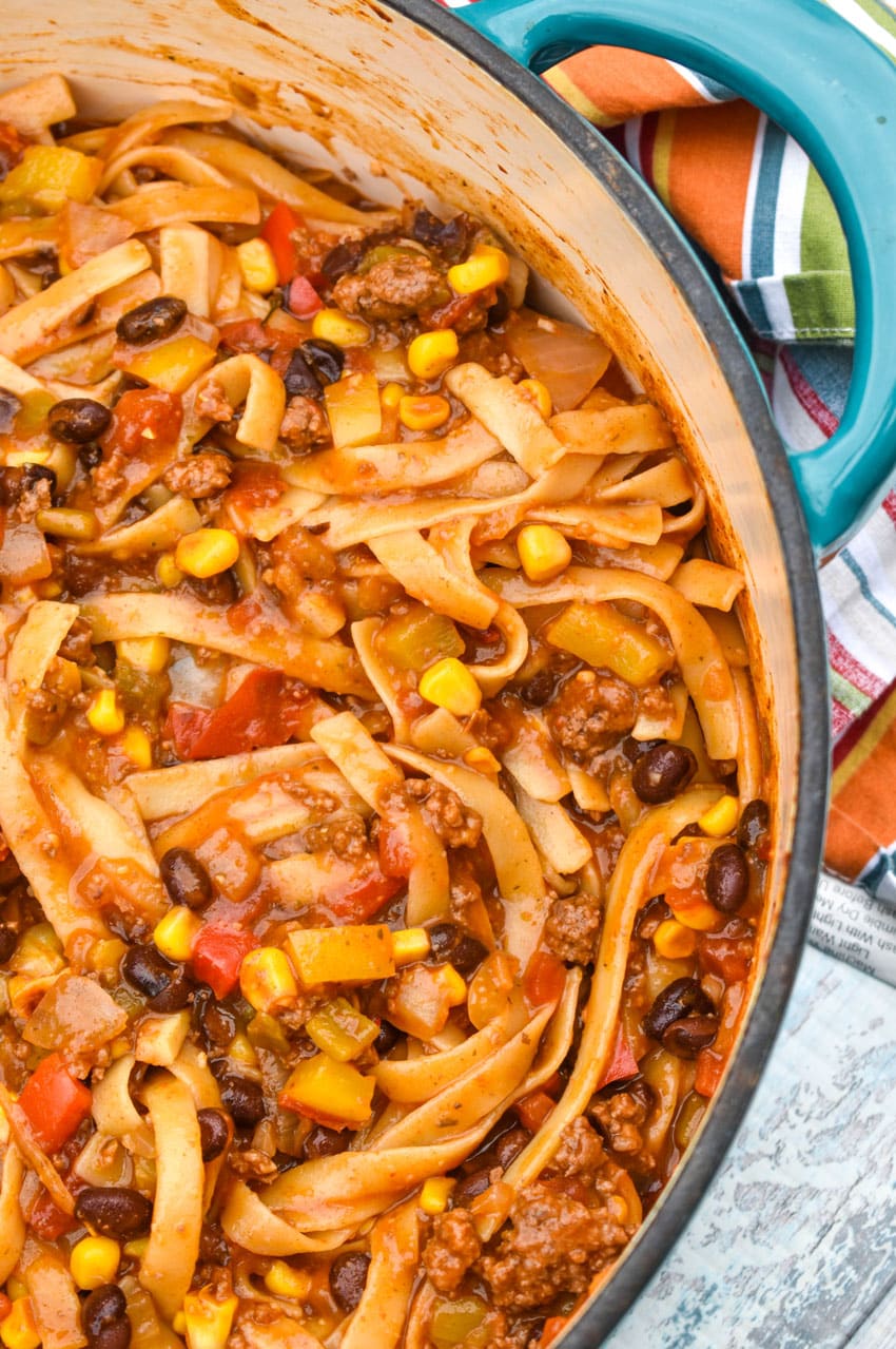 a close up of one pot taco spaghetti in a blue dutch oven