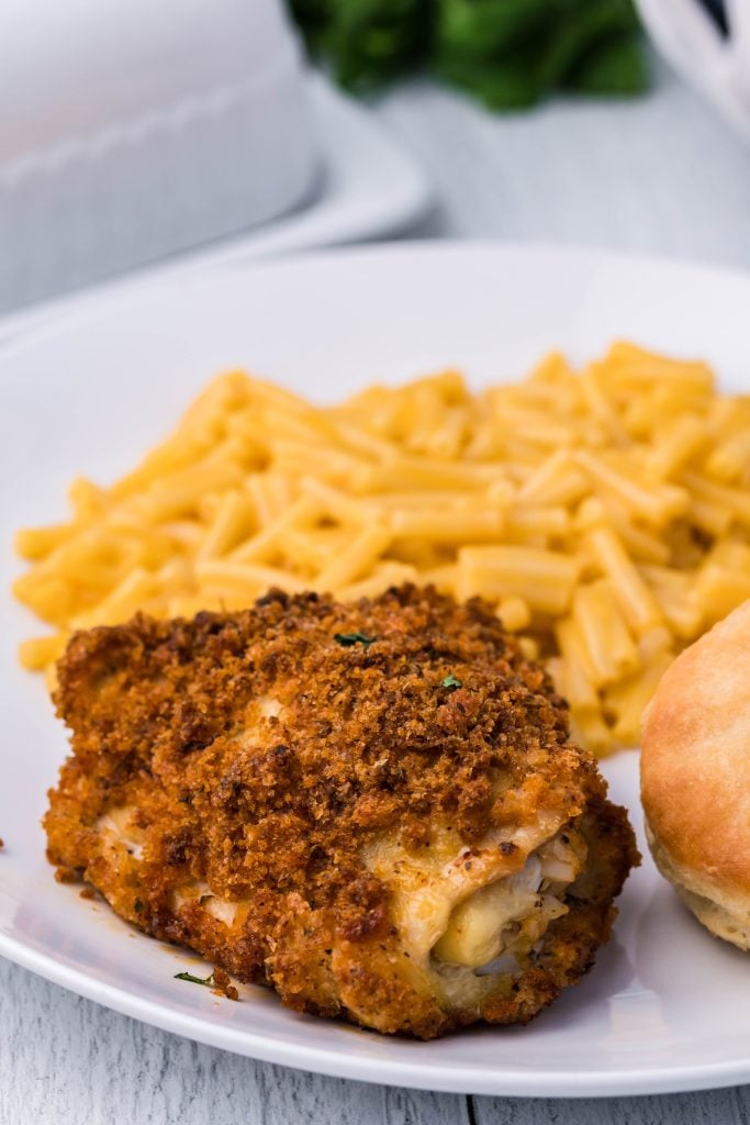 oven fried chicken on a white plate with mac and cheese on the side