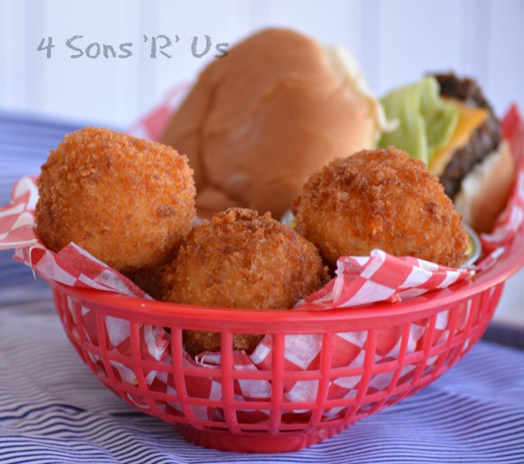 Giant Cheesy Tater Tots in a paper lined lunch basket with a hamburger