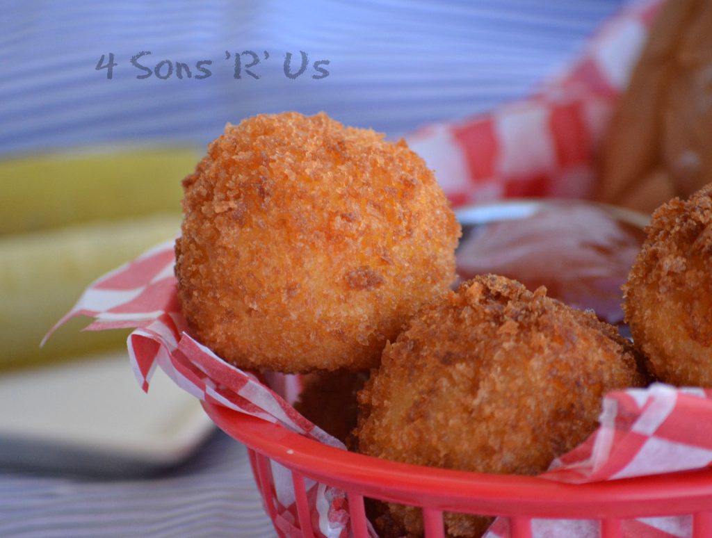 Giant Cheesy Tater Tots in a paper lined lunch basket with a hamburger
