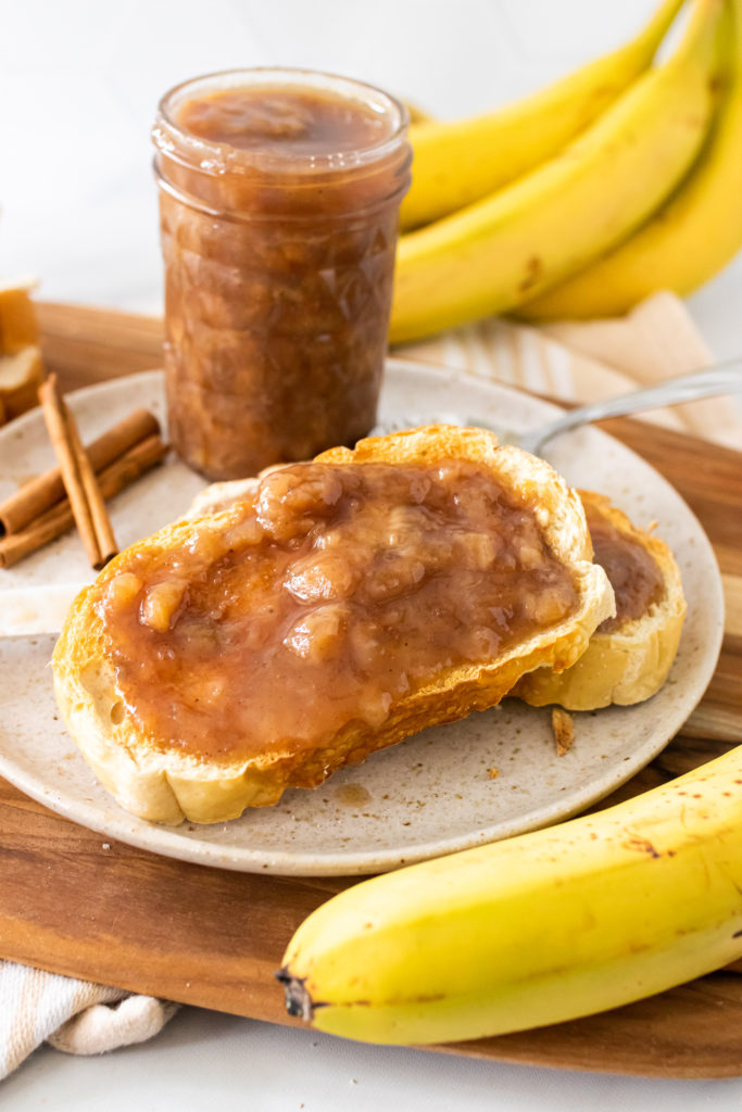 drunken monkey banana rum jam spread on two pieces of toast set on a white plate